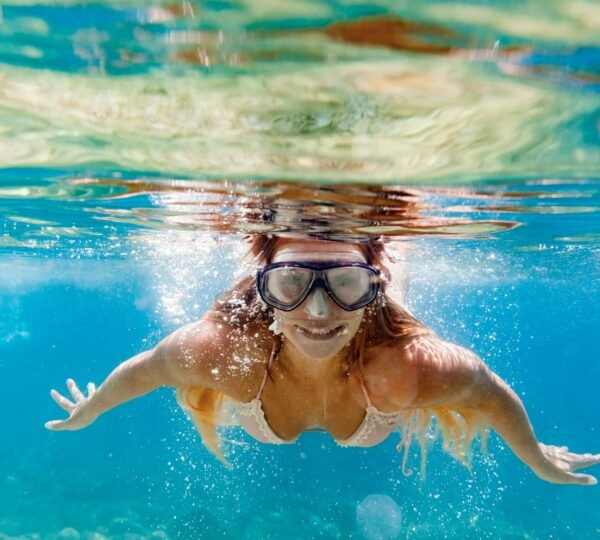 Woman snorkeling in the clear sea water