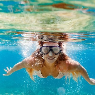 Woman snorkeling in the clear sea water